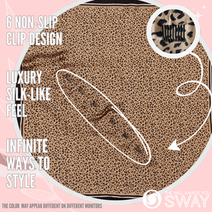 Leopard print headband laid flat to show design and clips 