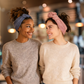 Two women wearing SWAY stretch headband styled in two different ways