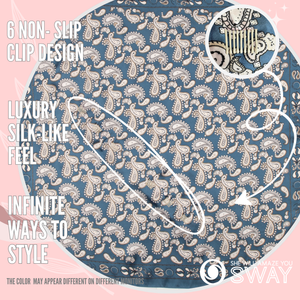 Slate, blue paisley pattern silky scarf laid flat with clips showing