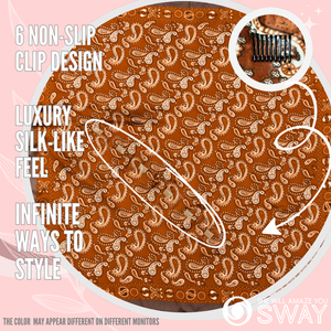 Rust colored paisley design laid flat to show non-slip clips